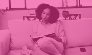 Young girl sitting on sofa with headphones on writing her goals in a journal and setting intentions for 20205