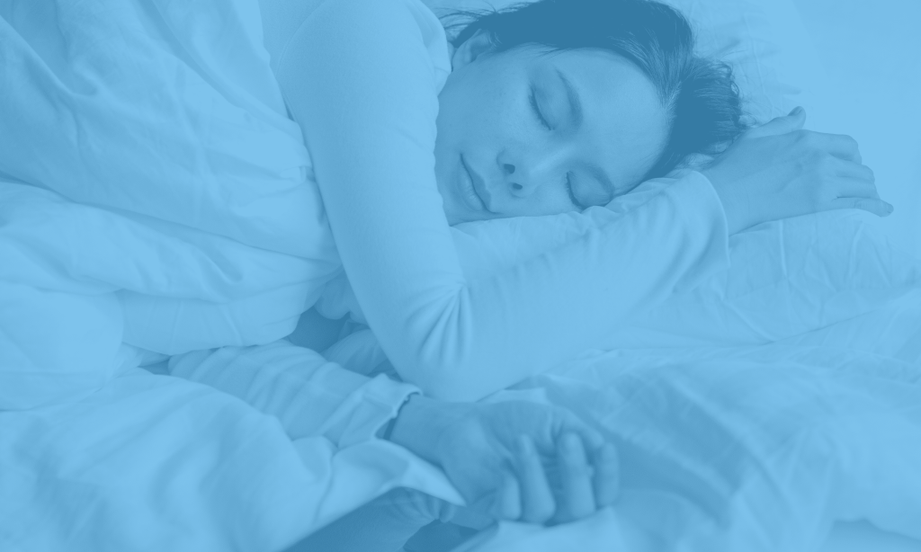 Sleep training. A woman lying in bed with her eyes closed